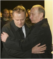 Donald Tusk and Vladimir Putin embrace themselves in Smolensk after the crash.